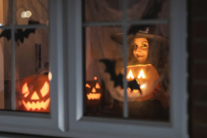 jack-o-lanterns and bats in the window